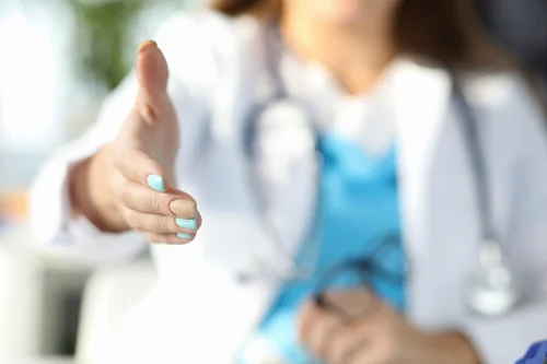 врач протягивает руку помощи при лечении анорексии